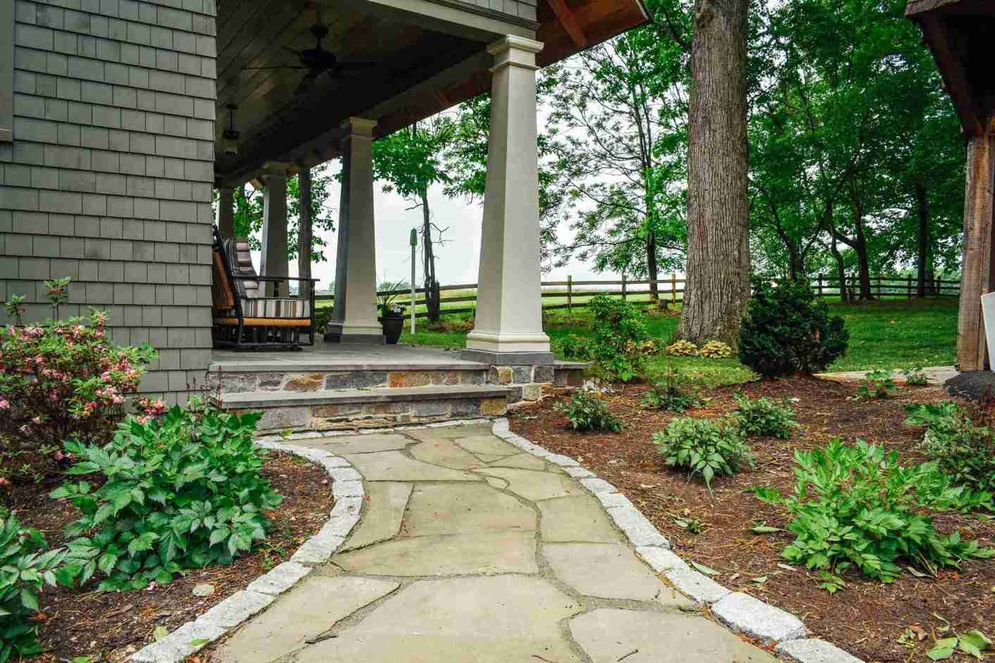 Flagstone walkway with flowering plants — seasonal color in Landenberg