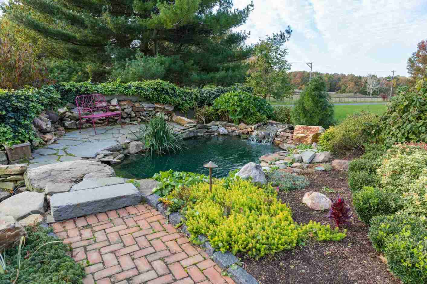 Koi pond with waterfall feature integrated into a drainage solution