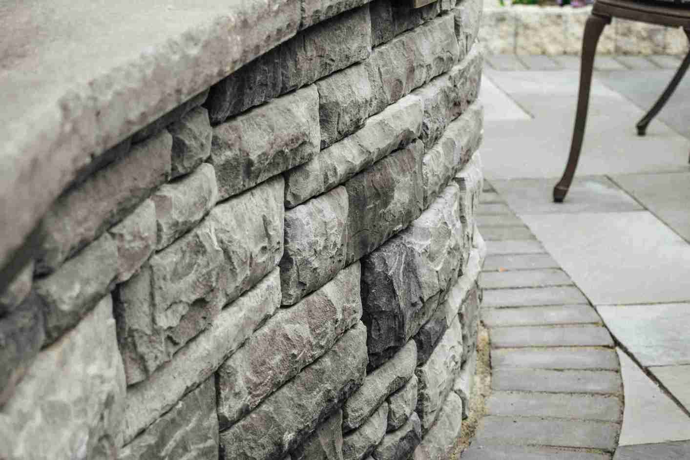 Stone entry pillars with paver driveway