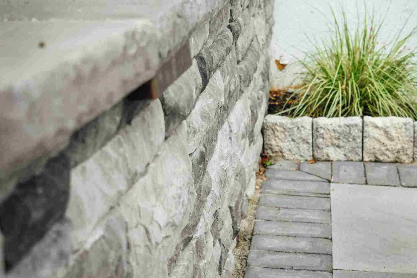 Stone veneer entry steps highlighted with landscape lighting in West Chester