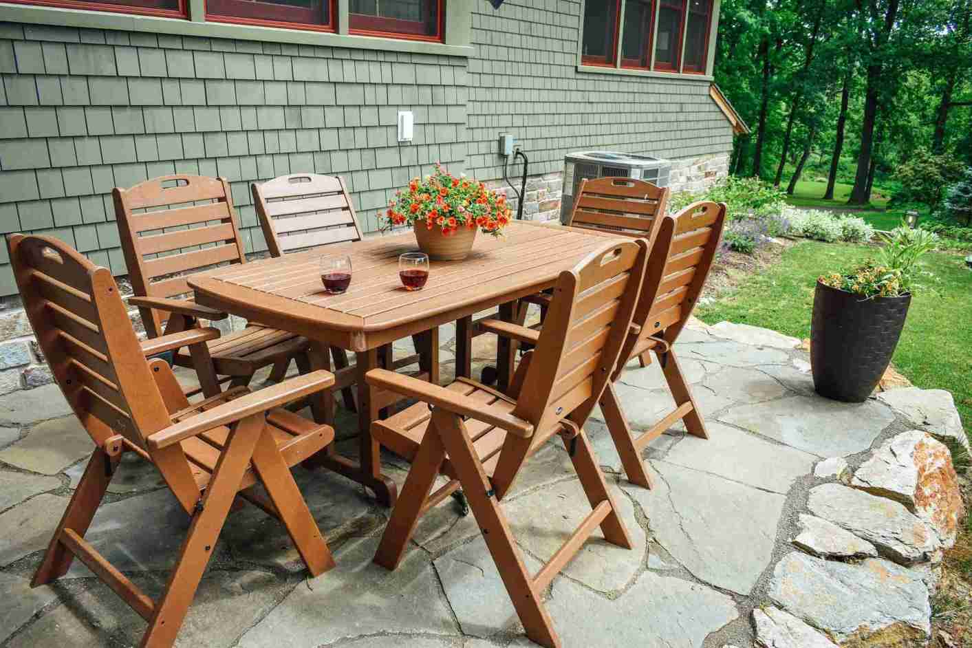 Wooden dining set on flagstone patio — outdoor living in Wilmington