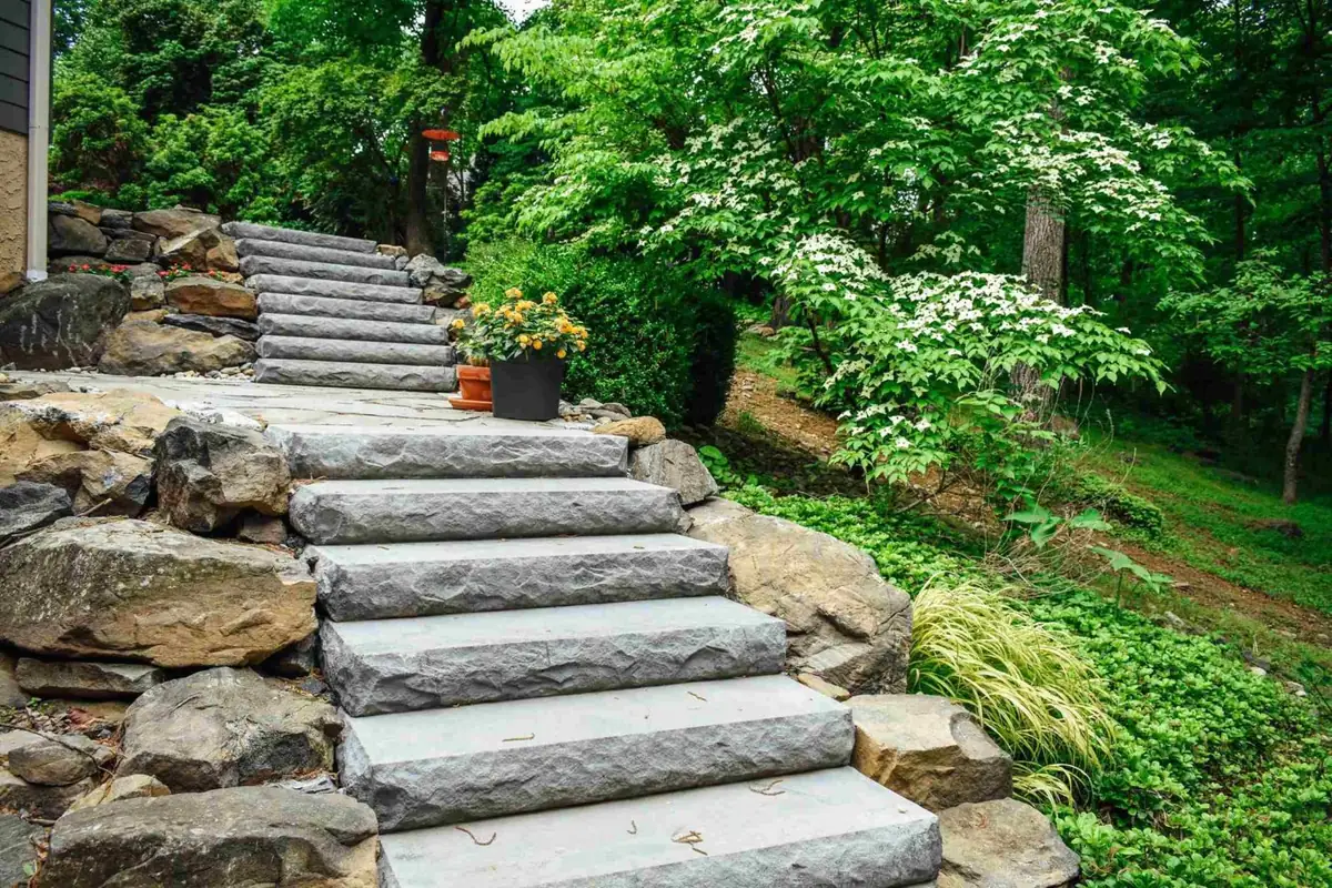 Boulder-lined stone steps with hostas