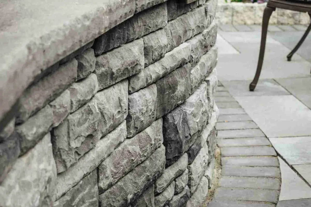 Stone entry pillars with paver driveway