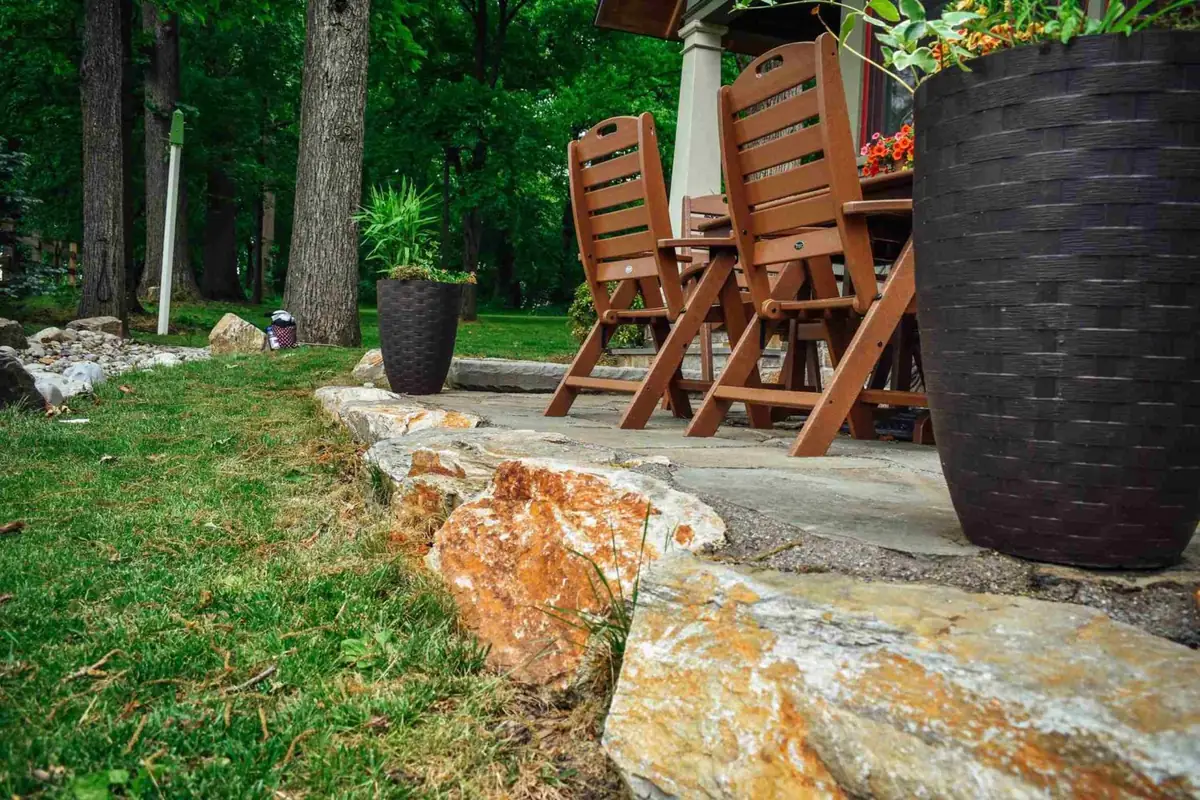 Stone wall patio detail with bluestone cap
