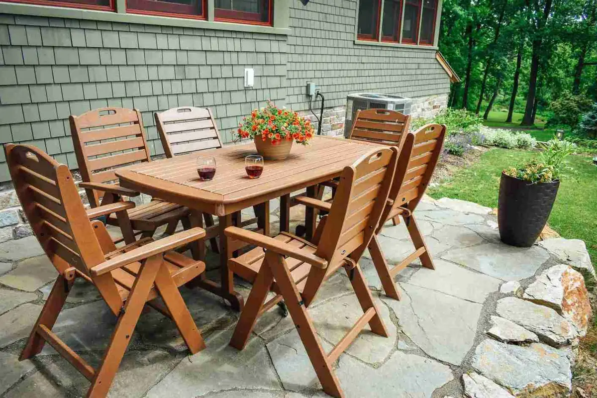 Wooden dining set on flagstone patio